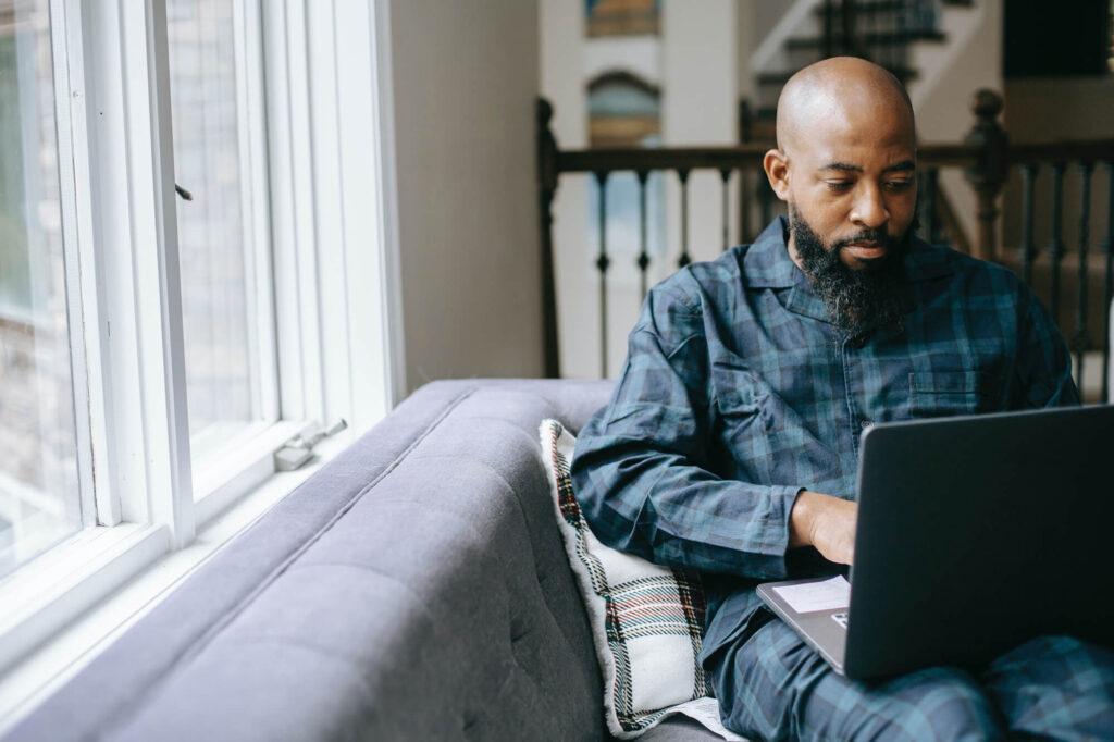 man in pajamas using laptop