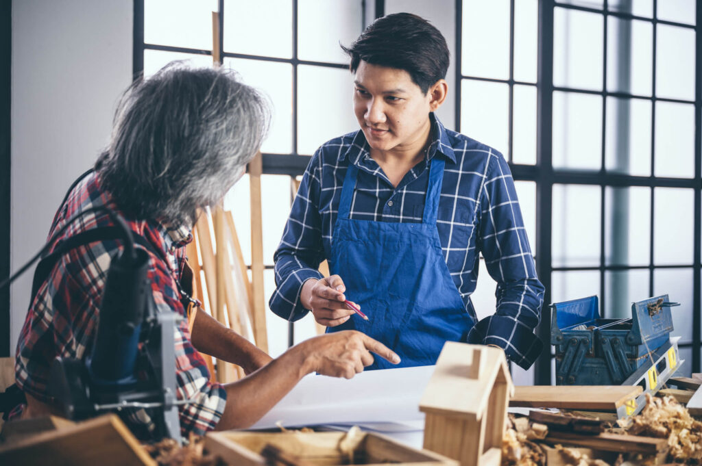 man and woman having a conversation in a woodshop