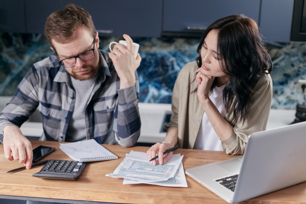 Man and a woman looking at bills